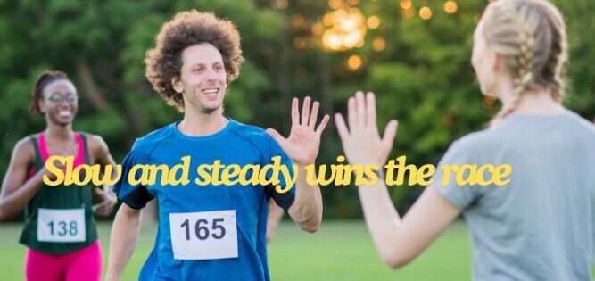 Three runners in a marathon. One man is High Fiving a lady during the run.